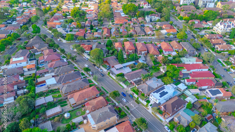 Obraz premium Aerial Panorama Drone View of a inner western Sydney Suburb of Ashbury Urban Sprawl and the terracotta roof tops streets and trees of Suburban Sydney NSW Australia