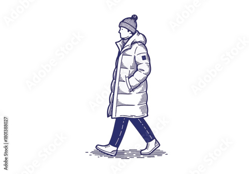 Person in a warm winter coat and hat walks casually on a snowy path, showcasing winter fashion and outdoor lifestyle in a cold environment with a relaxed atmosphere