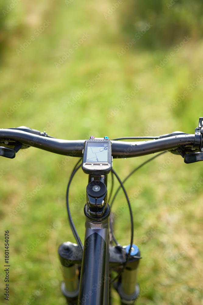 Naklejka premium Biker perspective on wooded path outdoors