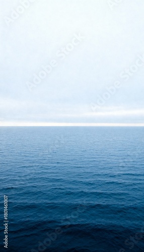 Calm Blue Ocean Horizon Under a White Sky water