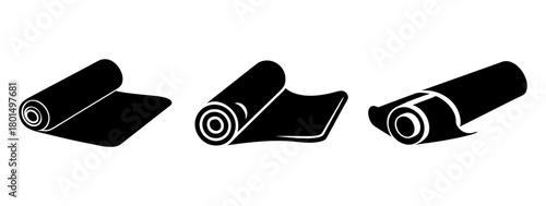 Three rolled up black mats or fabrics, shown from different angles, suggesting materials or textiles