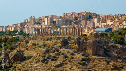 Aerial closeup of the Temple of Hera (or Roman Juno), Sicily, Italy. Known as Temple D, it's a Greek temple in the Valley of the Temples. In the background is the skyline of the city of Agrigento.