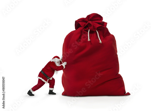 Close up of Santa Claus pushing huge bag of presents isiolated on transparent background, png file