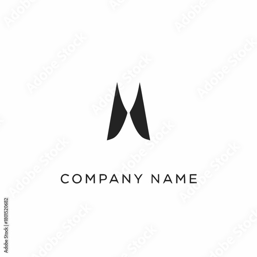 Abstract black letter M logo design on white background.