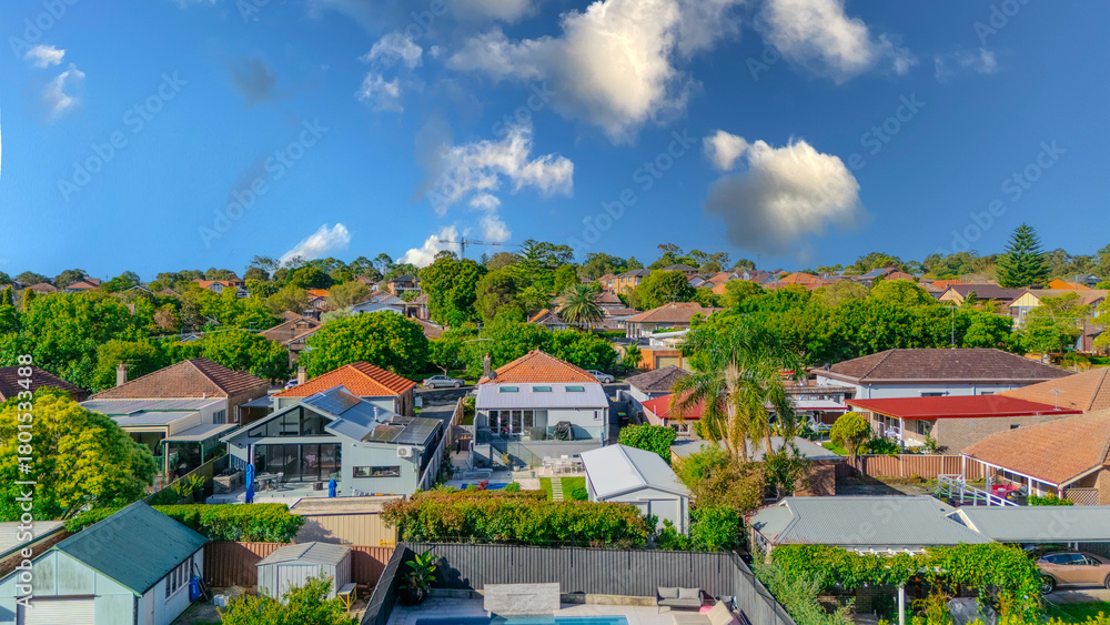 Obraz premium Aerial Panorama Drone View of a inner western Sydney Suburb of Ashbury Urban Sprawl and the terracotta roof tops streets and trees of Suburban Sydney NSW Australia