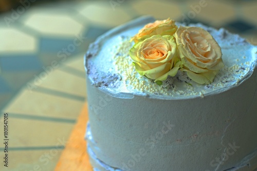 Cake decorated with three fresh roses, birthday, celebration