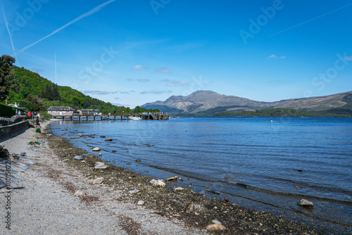 Sunny summer landscape view across the blue waters of Loch Lomond, Scotland