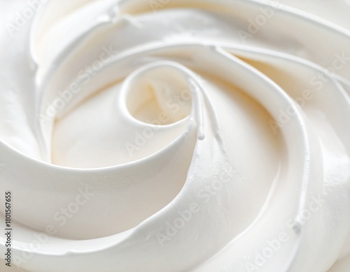 Macro photograph of a creamy, swirling white texture, resembling soft-serve ice cream or whipped cream