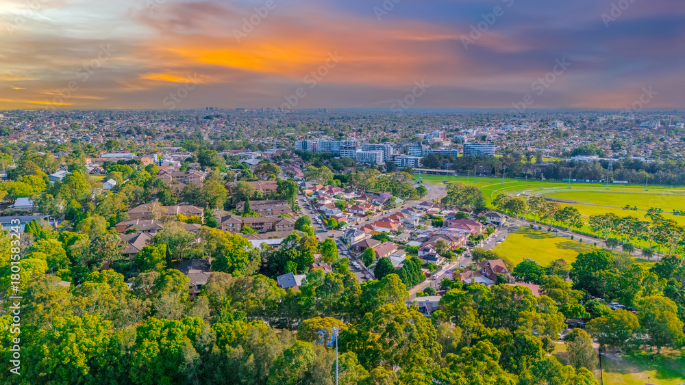 Obraz premium Aerial Panorama Drone View of a inner western Sydney Suburb of Ashbury Urban Sprawl and the terracotta roof tops streets and trees of Suburban Sydney NSW Australia