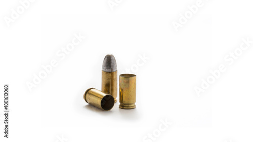 Isolated brass rifle ammunition cartridges on a white background signifying military danger and war