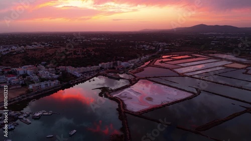 aerial shot above the salt pans in Fuseta fishing village on the Algarve Coast near Faro at sunset with beautiful colors, Portugal