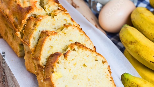 Freshly baked sliced banana bread with ripe bananas