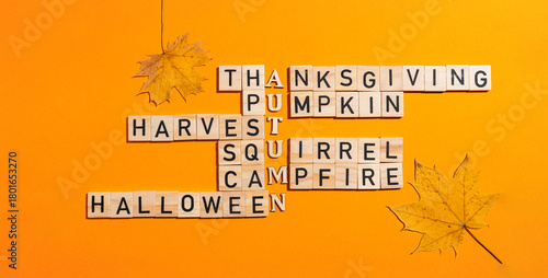 Autumn crossword puzzle with wooden letter blocks