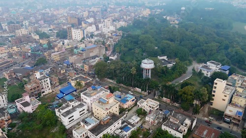 4K Drone Shot of Dense Indian Urban Landscape with Roads, Buildings and Light Morning Fog from Above.