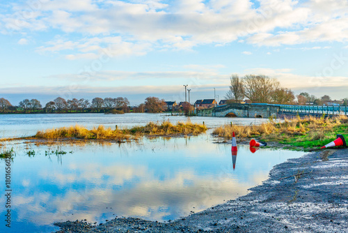 Flooding of agricultural fields at Bubwith near Selby,  East Yorkshire with flood water almost reaching the arches of Derwent Bridge and floating traffic cones. Copy space