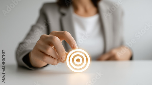 Target Focus: A person hand pointing on a glowing target at a desk, representing the importance of focus. This image symbolizes precision, ambition, and strategic planning.