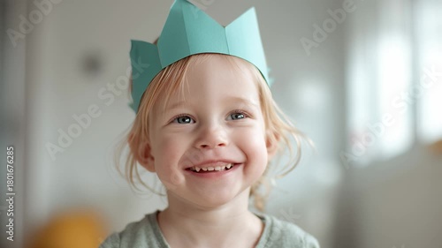 Adorable little girl in a paper crown smiling