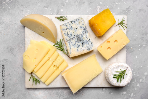 Italian and French gourmet cheese platter with craft cheese assortment on a marble platter. hard cheeses, mold cheese, gorgonzola, pecorino, Emmental, Roquefort cheddar