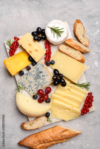 Italian and French gourmet cheese platter with craft cheese assortment on a marble platter. hard cheeses, mold cheese, gorgonzola, pecorino, Emmental, Roquefort cheddar