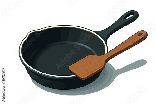 Dark cast iron frying pan with wooden spatula on white background