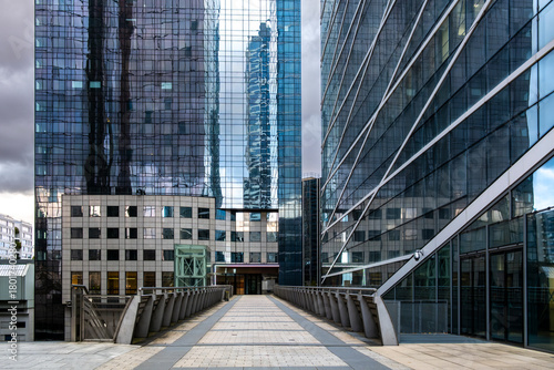 Corporate architecture in La Defense, paris shows modern towers, reflections and verticality forming a skyline linked to business and urban finance