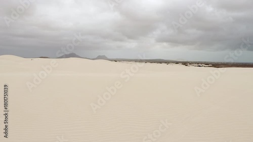 Sand dunes in Viana desert close up at overcast day, background mountains, Boa vista , Cape Verde.