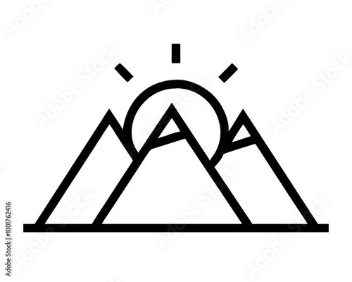 Mountain range with sun rising behind peaks