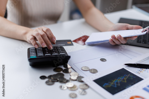 Photography Stressed business woman, employee using calculator to calculate expenses of monthly, hand holding bills and receipt for to payment on table at home