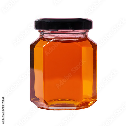 Golden honey filling hexagonal glass jar with a black lid