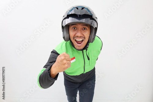 Portrait of Asian online taxi man showing running gesture with excited expression, isolated on white background, concept of energy, motivation, success, and active lifestyle.