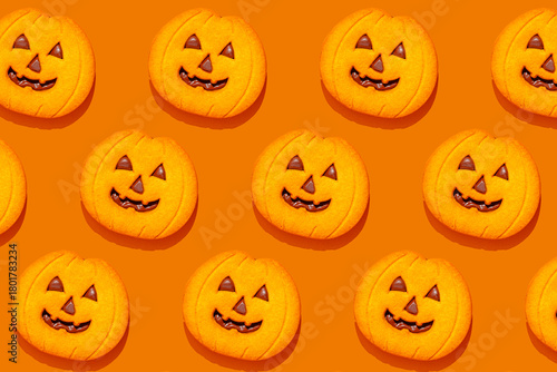 Halloween pumpkin cookies pattern on orange background