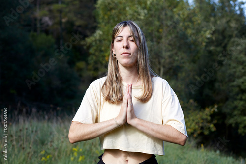 Peaceful woman meditating in a serene forest setting