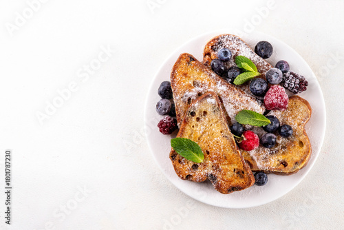 Leftover Christmas Spiced Stollen French Toasts, sweet fried stollen toasts with sugar powder and berries, Christmas morning dessert snack