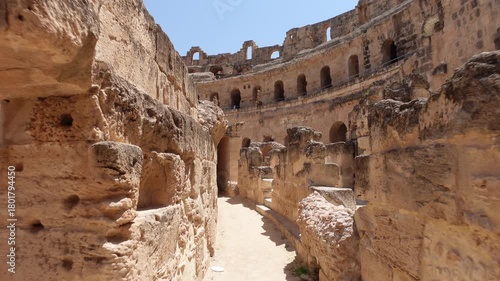 Tunisia history and architecture, walking through corridor inside the massive El Jem Amphitheatre, an important landmark and popular tourist destination
