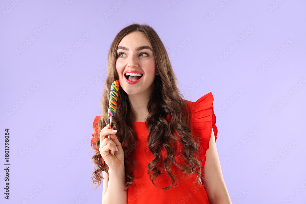 Naklejka premium Beautiful woman with lollipop on violet background
