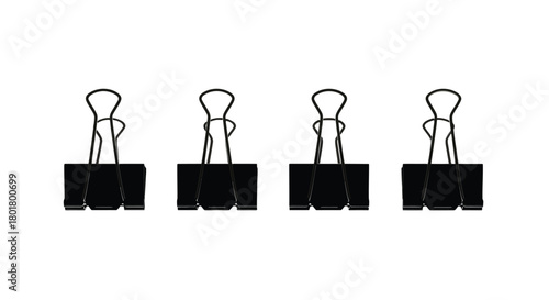 Four black binder clips for office supplies