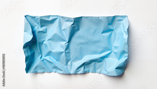 Crumpled light blue paper on white background, textured minimalism with soft contrast