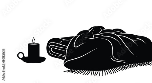 Cozy black silhouette of a lit candle next to a folded warm blanket with fringe on a white background
