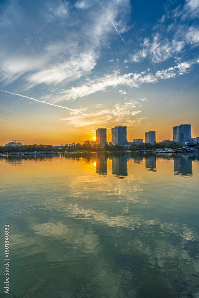 Fototapeta premium Sunset scenery by the city lake