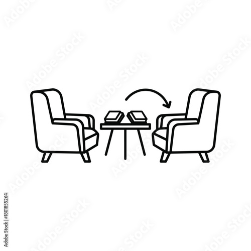 Discussion space with two armchairs, coffee table, and books, symbolizing communication and exchange