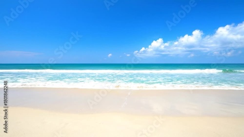 Wallpaper Mural A tranquil scene of a sandy beach, turquoise ocean, and bright blue sky with fluffy clouds Torontodigital.ca