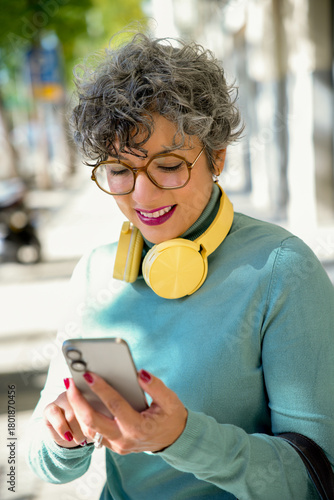 Stylish tech-savvy woman enjoying a sunny day outdoors