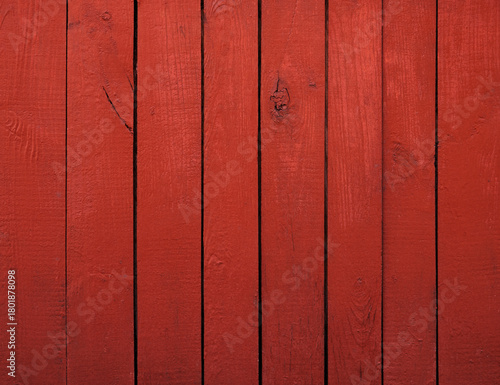 Close up of red painted wooden fence panels.