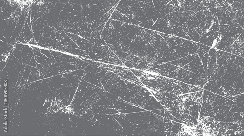 Detailed close up of a distressed grey textured surface with white scratches and speckles creating a grunge effect