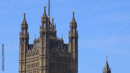 Victoria tower seen from Parliament Square Garden on a sunny day with blue sky in London