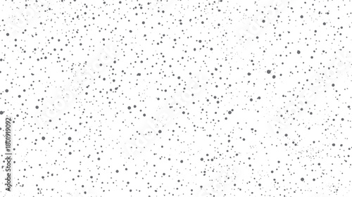 White background with scattered irregular grey dots and speckles of varying sizes and densities texture