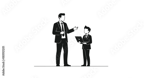 Adult businessman in suit pointing at a young boy in a suit holding a book or tablet