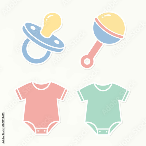 Baby essentials set with pacifier rattle and two bodysuits in pastel colors.