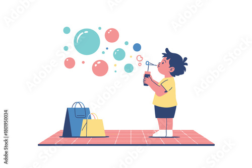 A child blows bubbles while standing on a mat with shopping bags nearby.