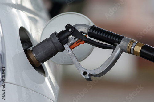 Close-up of Compressed Gas Nozzle Refueling a White Vehicle
